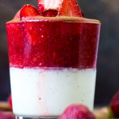 Strawberry Panna Cotta recipe with many strawberries around the cup