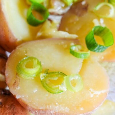 Simple Boiled Red Potatoes on a plate with spring onion