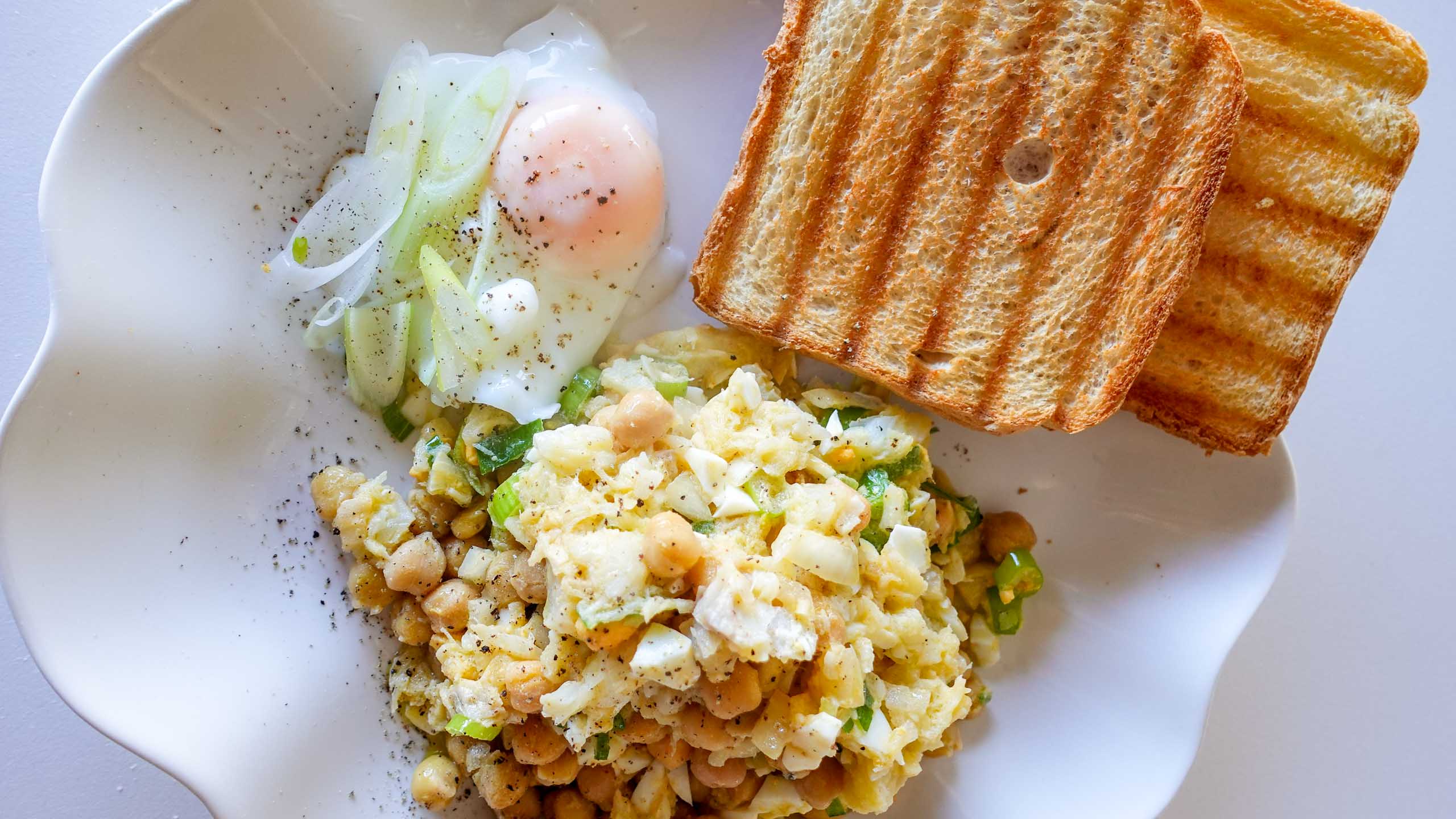 Salad with bread and egg on a plate