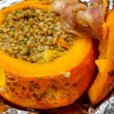 Delicious Stuffed Pumpkin in a pan with a piece of bacon.